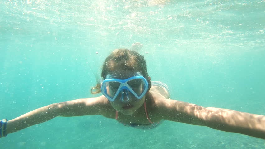 A little girl with swimming mask exploring underwater in the Mediterranean Sea | Shutterstock HD Video #1022892631
