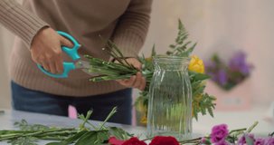 Close up of florist arrange flowers, using scissors cutting branch of flowers. young woman working in the florist shop. the concept of small business and flower lifestyle 4k clips