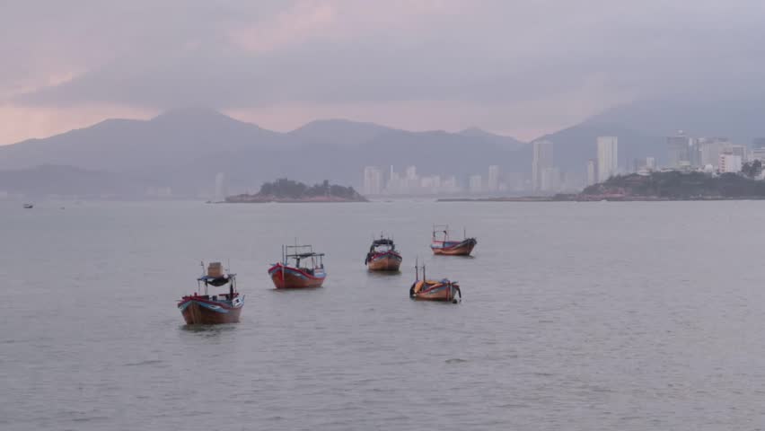 fishing boats in Vietnam near the sea with a view of the dawn, city, mountains, islands, time lapses