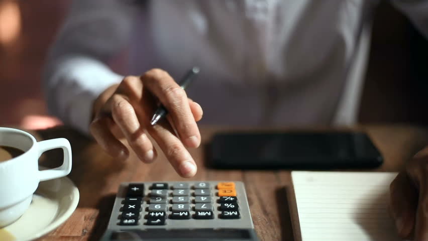 Close up of businesswoman or accountant hand holding pen working on calculator to calculate business data, accountancy document and laptop computer at office, business concept  Royalty-Free Stock Footage #1022911414