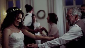A young bride dancing with grandfather and other guests on a wedding reception. - Powered by Shutterstock - Get 15% off with code: PIKWIZARD15