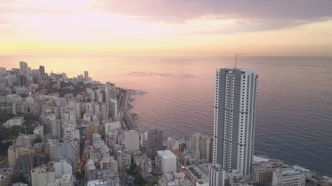 Flying over Beirut bay marina and downtown. Drone aerial shot of Beirut, Lebanon, during sunset.