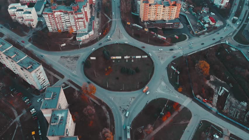 Aerial view to the road circle with city cars traffic 4k cinematic color, side view