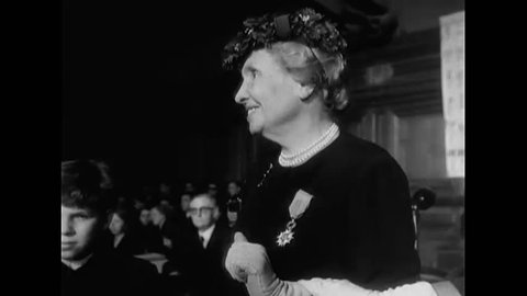 CIRCA 1950s - Author and political activist Helen Adams Keller receives a medal and a bouquet of flowers after lecturing at an assembly.