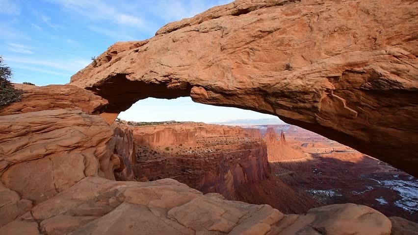 Mesa Arch in evening light at sunset. The sandstone rock formation acts like a window to the canyons and desert landscapes of Canyonlands National Park in Utah.
