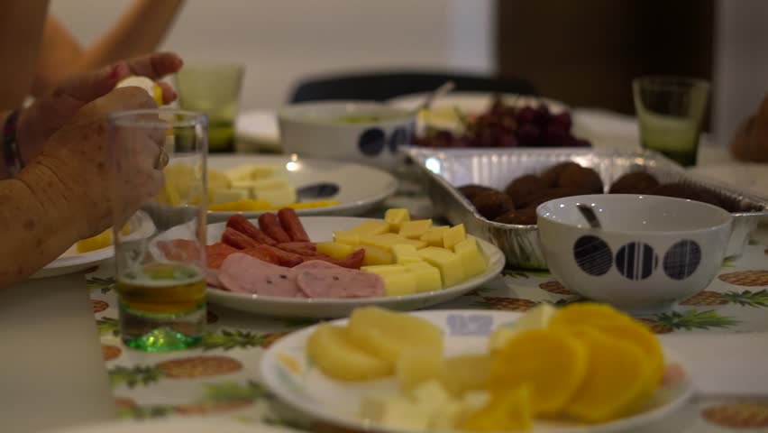 Group of people eating traditional food at the northern coast of Colombia in south America.. Bollo de yuca, bollo de mais y kibbeh, which has a lot of Lebanese influence in the coast. 
