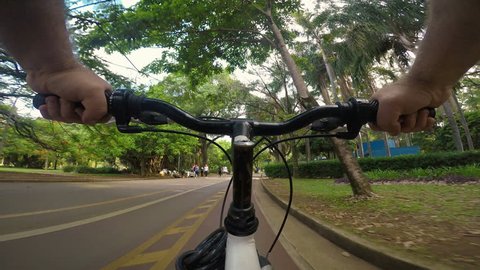 Sao Paulo, Brasil, November 30, 2018. Gopro camera POV of cyclist pedals along the cycle path of the Ibirapuera Park, south zone of Sao Paulo