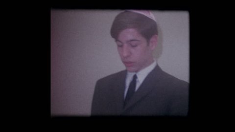 1967 Jewish boy prays at start of Passover seder