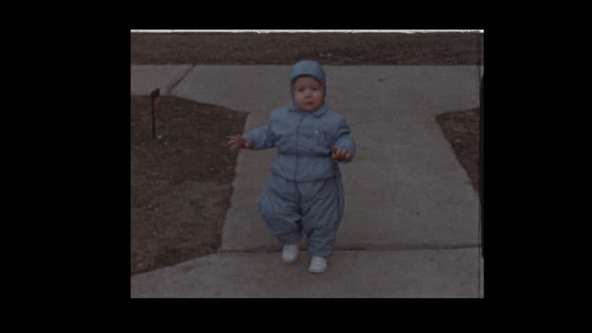 1954 Little boy bundled up in cold winter snowsuit