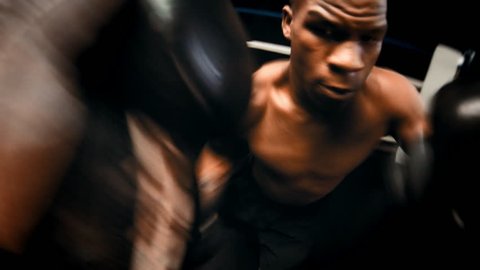 Point of view shot of a professional boxer throwing punches in a boxing ring