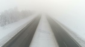 Winter highway in the fog. Aerial video