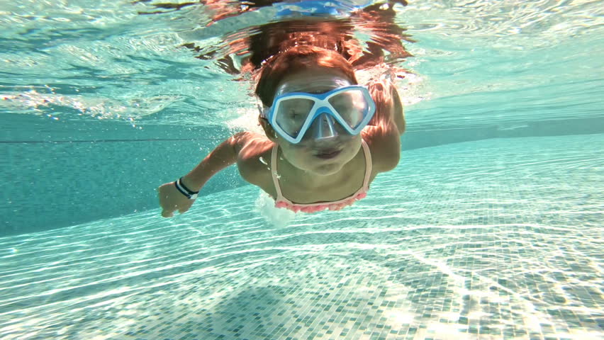 Little girl wearing snorkeling mask swimming underwater in the pool. Slow motion | Shutterstock HD Video #1022974468