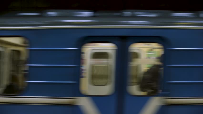 CINEMAGRAPH - Blue subway train with people inside moving fast, view from metro station. Close up for windows of subway train passing fast at underground station Royalty-Free Stock Footage #1022979223