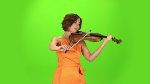 Musician in the studio plays the violin. Green screen