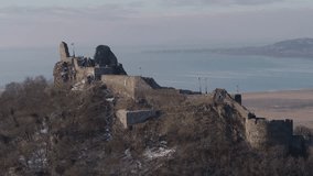 Hungary - aerial video of the ruined castle near the town of Szigliget overlooking the Lake Balaton in winter