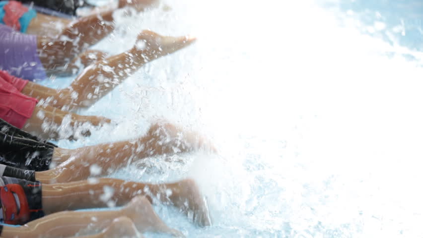 children learning swimming class in swimming pool