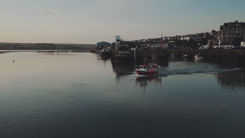 Fishing boat leaving Padstow Harbour at first light.