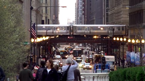 CHICAGO - APRIL 17:
Traffic on the West Washington Street with a Chicago 'L' train on elevated tracks at background.
April 17, 2015 in Chicago, Illinois, USA