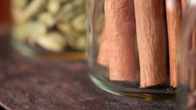 Close up footage of various exotic spices in glass jar. Panning to the right. Selective focus.