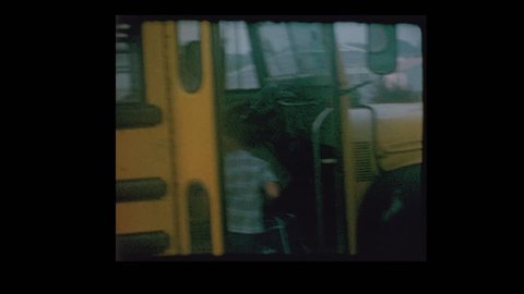 1964 Mother kisses son goodbye and Little boy gets on antique school bus