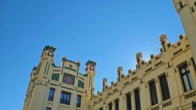 A gorgeous video of the sun rising behind the exterior facade of the popular railway station, The North Station, Estación del Norte, or Estació del Nord, located in city of Valencia, in Spain, Europe.