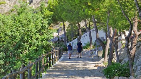 A video of a park in the top of a mountain. This beautiful path goes to the medieval castle and the Sanctuary of the Virgin of the Castle, or Santuario De La Virgen Del Castillo, in Cullera, Valencia.