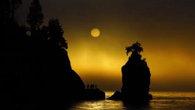 Siwash rock and sunset with foggy background,Vancouver BC Canada