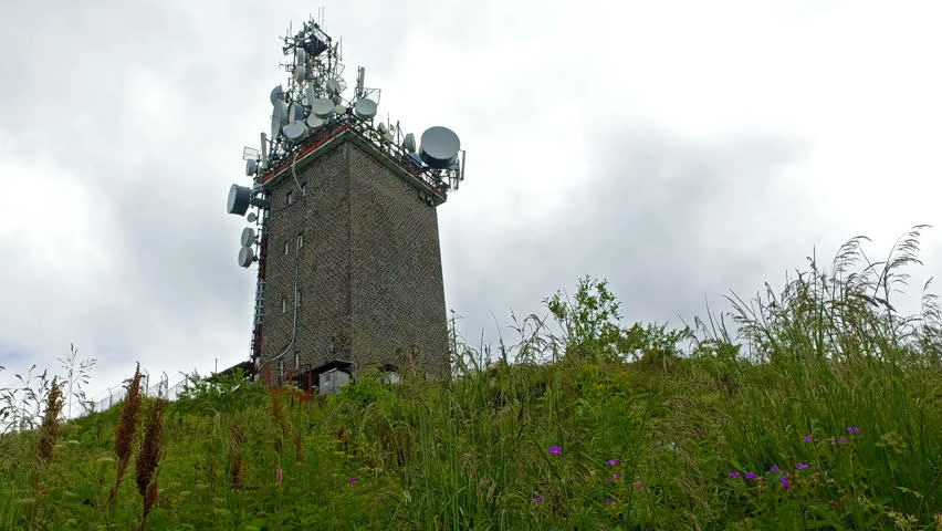 Communications Tower And Cable Cars Beside Lush Mountain Pine Forest
