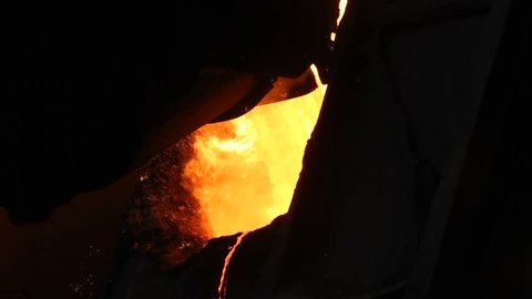 The process of pouring hot iron for steel production. Plant for the production of metal.Slo