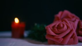 Footage of move flower rose and candle burning. Valentine day