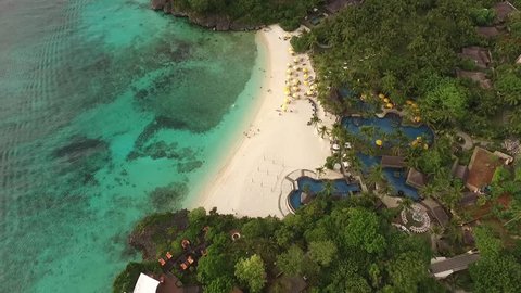 Aerial view of popular beach and scuba diving resort area. Boracay is Island near Puerto Galera, Mindoro, Philippines. South East Asia. Beautiful sunset over evening sea in Pacific Ocean. 