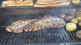 Grilled pork ribs on the grill and fried potatoes grilled