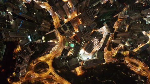 Bird eyes view of Hong Kong cityscape from the drone at night time. 90 degrees aerial view from drone of Hong Kong city. Drone is Flying Forward.