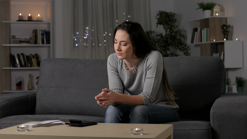 Single sad woman complaining reading a letter in the night sitting on a couch at home Royalty-Free Stock Footage #1023078511