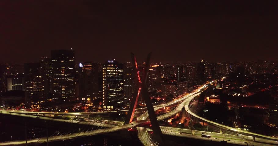 Aerial night view of The Octavio Frias de Oliveira bridge, cable-stayed bridge in Sao Paulo, Brazil over the Pinheiros River with thunder sky