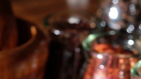 Close up footage of cardamom spices in glass jar. Panning to the right, selective focus.