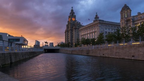 Liverpool / United Kingdom - June 11 2017: A timelapse video with sunset at the Liverpool canal link with the Pier Head Ferry Terminal and the Royal Liver Building