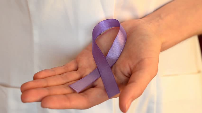 Doctor keeps a purple ribbon as a symbol of epilepsy awareness day around the world close up | Shutterstock HD Video #1023092089
