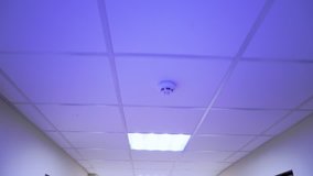 Surveillance cameras on the ceiling. Office security service. POV. Camera on the wall. Human face detection technology.