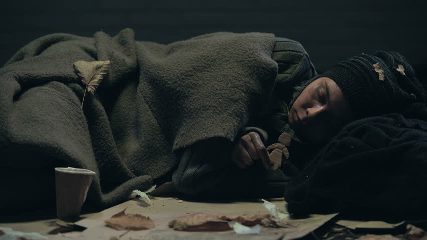 Lonely homeless person with paper figure lying on street missing home and family | Shutterstock HD Video #1023101587