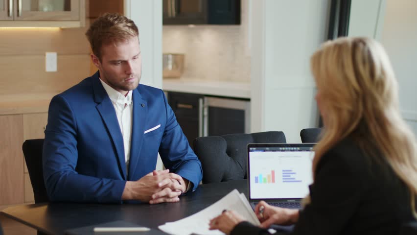 Client making a Busines deal by signing documents and shaking hands