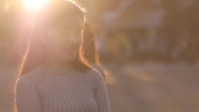 Vietnamese woman. Beautiful Asian girl smile in the sunshine. Stock video footage of a pretty Asia young woman with long hair nice smiling in sun light backlit. Beautiful girl in sunlight backlight