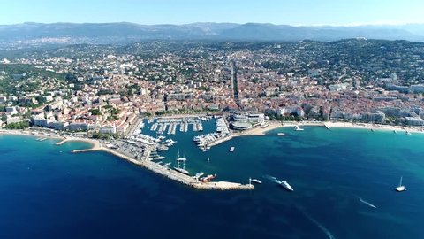 High altitude aerial shot from helicopter showing Cannes a city located on  French Riviera and host of annual Film Festival and known for its association with rich and famous 4k high resolution