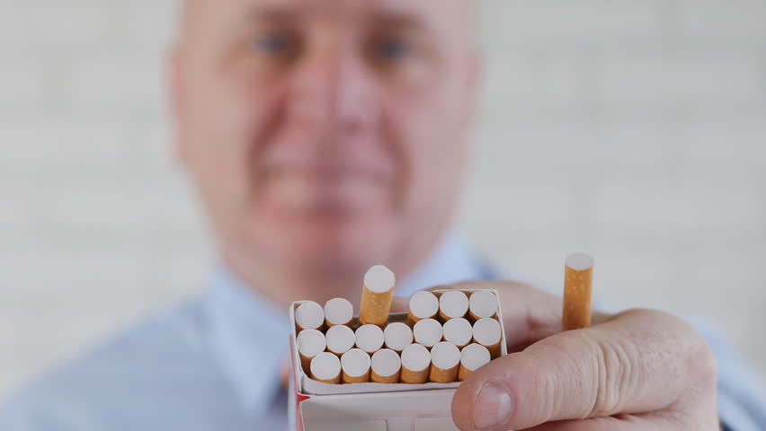 Person Taking a Smoking Pause Smile and Offer a Cigarette From a New Pack Royalty-Free Stock Footage #1023128794