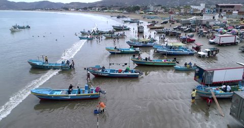 San Pedro, Ecuador - 09 15 2018: Puerto Lopez, Ecuador / September 13, 2018 - Drone Aerial - Flying Along Coast Filled With Boats and People