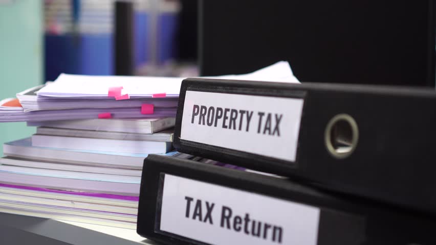 Tax return and property tax folders stack with label black binder on paperwork documents summary report in busy offices by manager checking. HR-human resources business bookkeeping accountancy Concept Royalty-Free Stock Footage #1023136360