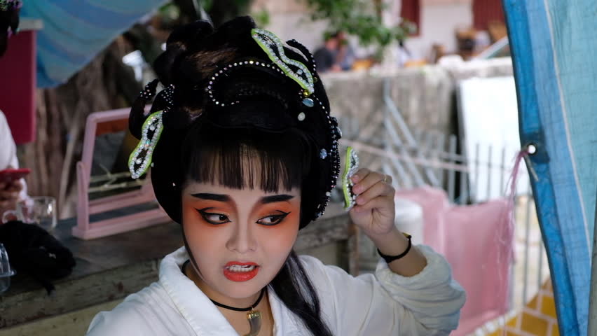 Georgetown, penang / malaysia - 07 08 2018: georgetown, penang, august 2018  - a chinese opera performer gets ready backstage in part of the hungry  ghost festival