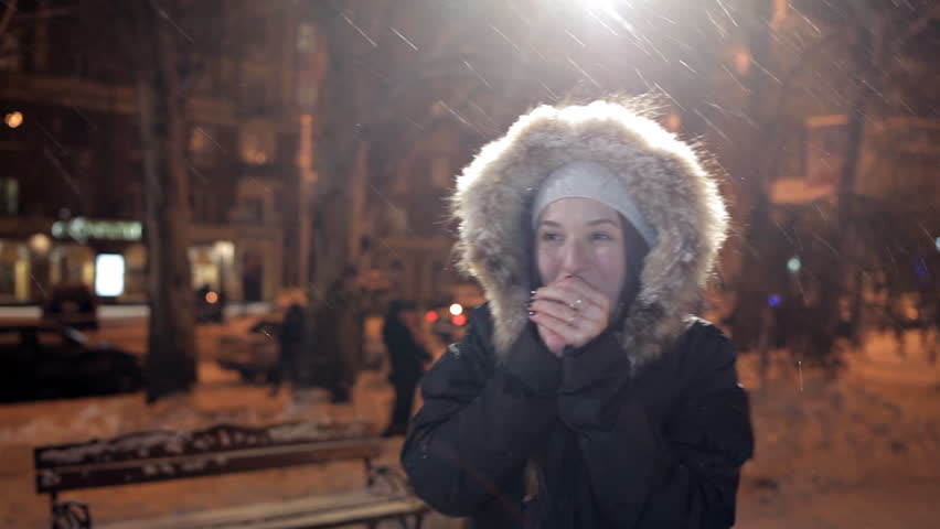 Two young girls in the winter evening, joyful and happy