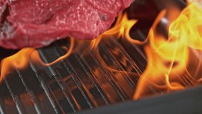 Super slowmotion footage of throwing fresh beef meat on ignited pan, 1000fps 4k