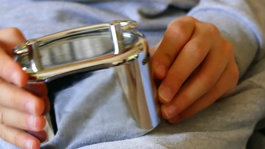 piggy bank and child, a child has a metal piggy bank in his hand,